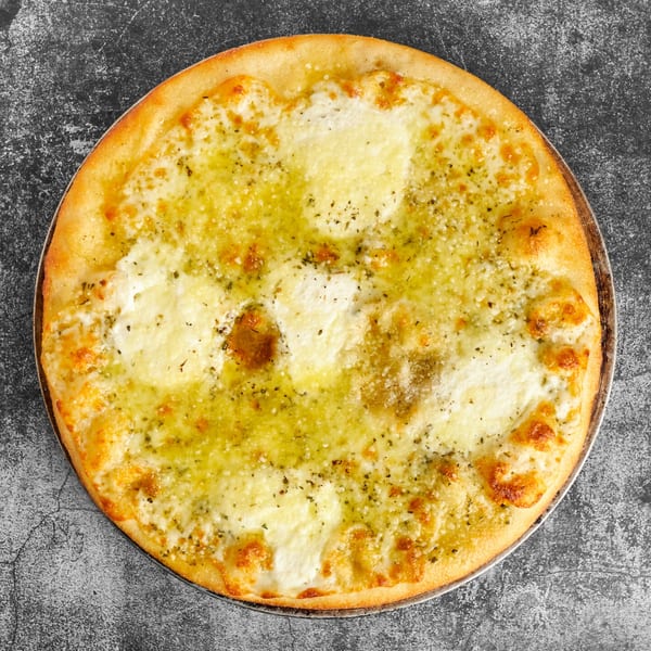 Trent's Pizzeria's garlic cheese pizza, topped with melted mozzarella, herbs, and olive oil.